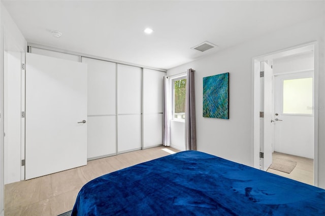904 Virginia Dr, Sarasota, FL 34234 - unfurnished bedroom with wood finished floors, recessed lighting, and a closet