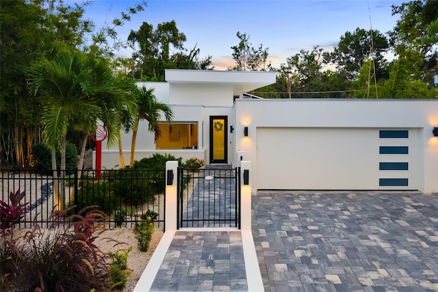 904 Virginia Dr, Sarasota, FL 34234 - contemporary home with stucco siding, a garage, a gate, and driveway