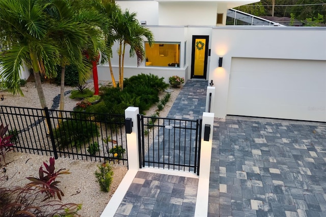 904 Virginia Dr, Sarasota, FL 34234 - view of front of house featuring stucco siding, a gate, and a garage