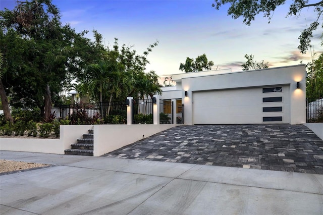 904 Virginia Dr, Sarasota, FL 34234 - contemporary home featuring decorative driveway, stucco siding, and a garage