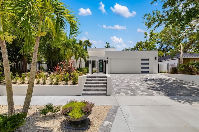 904 Virginia Dr, Sarasota, FL 34234 - modern home with decorative driveway, stucco siding, and a garage