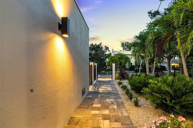 904 Virginia Dr, Sarasota, FL 34234 - property exterior at dusk featuring stucco siding and a gate