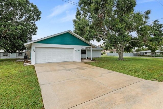 2708 Wilkinson Rd, Sarasota, FL 34231 - single story home with an attached garage, stucco siding, driveway, and a front yard