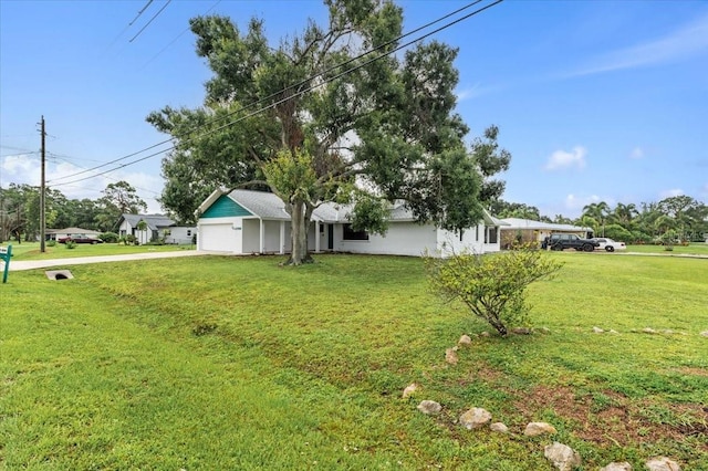 2708 Wilkinson Rd, Sarasota, FL 34231 - view of side of home with a garage, driveway, and a yard