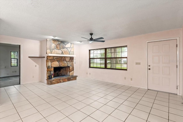 2708 Wilkinson Rd, Sarasota, FL 34231 - unfurnished living room featuring a textured ceiling, ceiling fan, healthy amount of natural light, and a fireplace