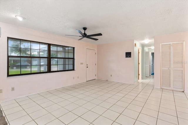 2708 Wilkinson Rd, Sarasota, FL 34231 - unfurnished room with a textured ceiling, a ceiling fan, and light tile patterned floors