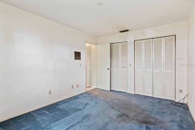 2708 Wilkinson Rd, Sarasota, FL 34231 - unfurnished bedroom featuring two closets and carpet