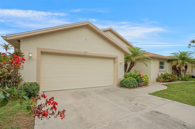 2710 93rd Ct E, Palmetto, FL 34221 - view of front of house with stucco siding, concrete driveway, and a garage