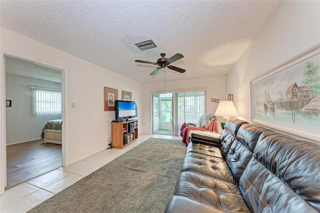 3905 34th Avenue Dr W Unit 36, Bradenton, FL 34205 - living room with light tile patterned floors, plenty of natural light, a textured ceiling, and ceiling fan