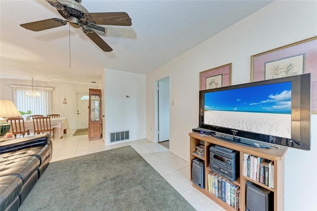 3905 34th Avenue Dr W Unit 36, Bradenton, FL 34205 - living area featuring light tile patterned floors, a textured ceiling, a chandelier, and a ceiling fan