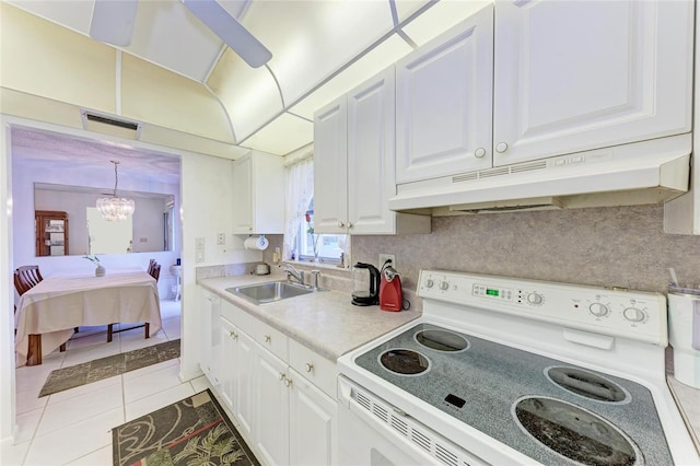 3905 34th Avenue Dr W Unit 36, Bradenton, FL 34205 - kitchen with electric range, a chandelier, light countertops, under cabinet range hood, and light tile patterned floors