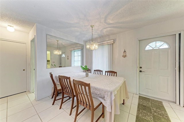 3905 34th Avenue Dr W Unit 36, Bradenton, FL 34205 - dining room featuring a chandelier, a textured ceiling, and light tile patterned flooring