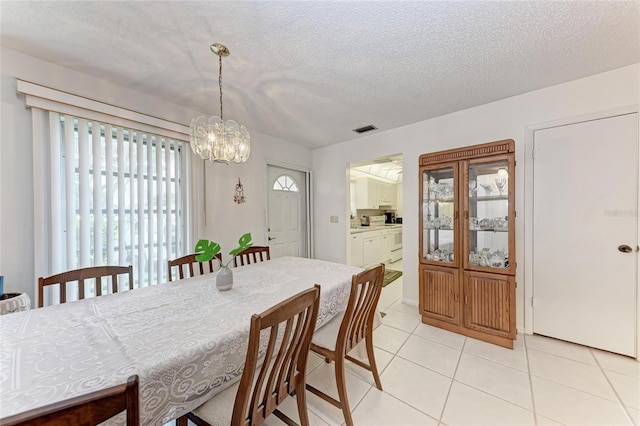 3905 34th Avenue Dr W Unit 36, Bradenton, FL 34205 - dining room with light tile patterned floors, a chandelier, and a textured ceiling
