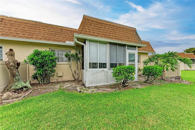 3905 34th Avenue Dr W Unit 36, Bradenton, FL 34205 - view of property exterior featuring a shingled roof, mansard roof, and stucco siding