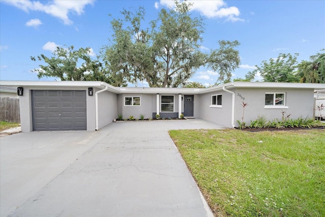 3959 Coleridge Pl, Sarasota, FL 34241 - ranch-style house with an attached garage, stucco siding, driveway, and a front lawn