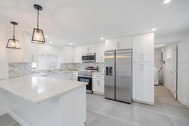 3959 Coleridge Pl, Sarasota, FL 34241 - kitchen featuring appliances with stainless steel finishes, a peninsula, backsplash, white cabinetry, and recessed lighting
