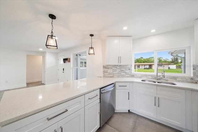 3959 Coleridge Pl, Sarasota, FL 34241 - kitchen with stainless steel dishwasher, tasteful backsplash, a peninsula, recessed lighting, and white cabinetry
