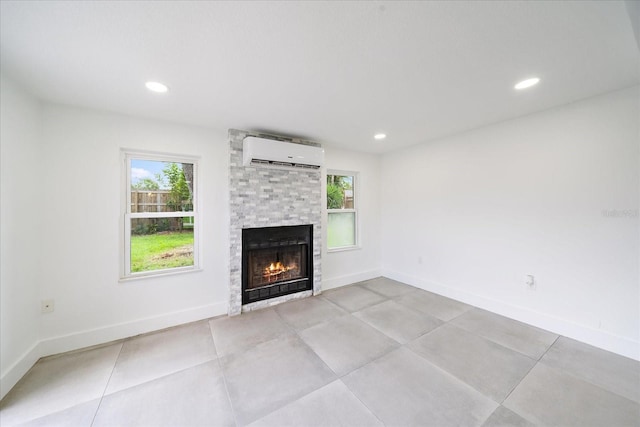 3959 Coleridge Pl, Sarasota, FL 34241 - unfurnished living room with a wall mounted air conditioner, healthy amount of natural light, a fireplace, and recessed lighting