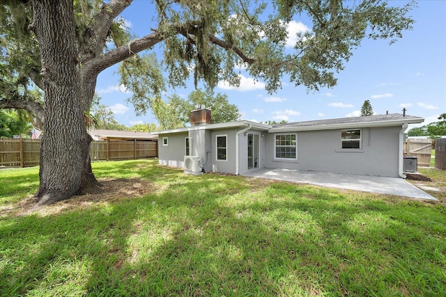 3959 Coleridge Pl, Sarasota, FL 34241 - back of property featuring stucco siding, a fenced backyard, a patio area, and a chimney