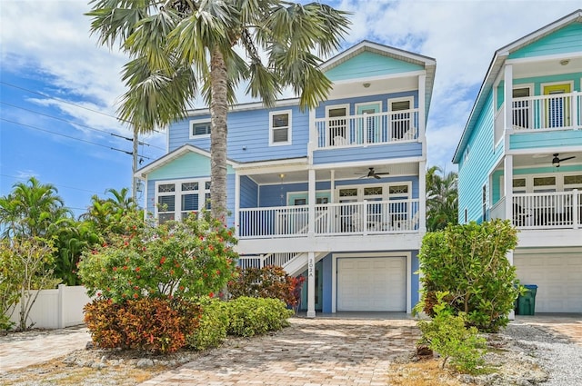 202 75th St, Holmes Beach, FL 34217 - beach home featuring ceiling fan, stairs, an attached garage, a porch, and a balcony