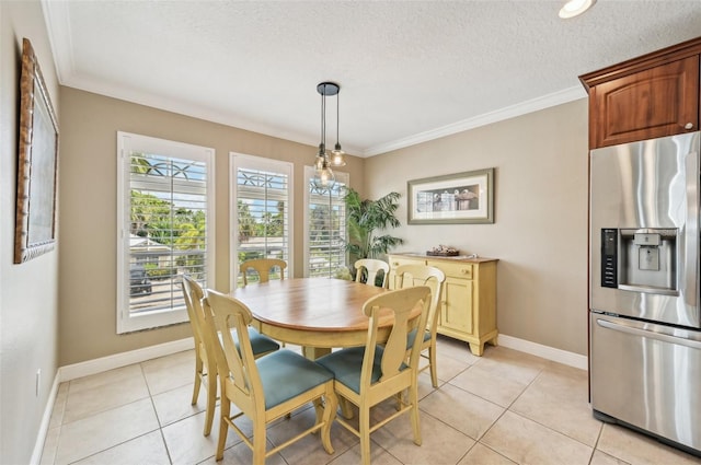 202 75th St, Holmes Beach, FL 34217 - dining space with a textured ceiling, light tile patterned flooring, and ornamental molding