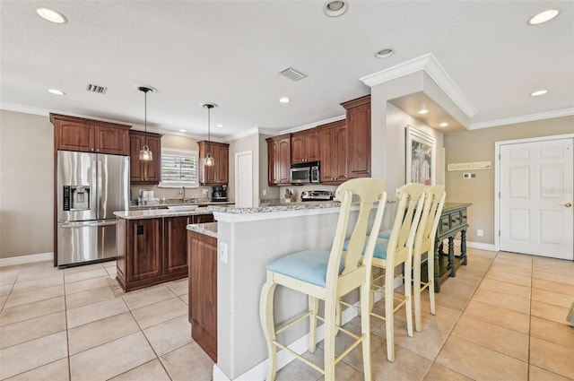 202 75th St, Holmes Beach, FL 34217 - kitchen featuring stainless steel appliances, crown molding, light tile patterned floors, recessed lighting, and light stone countertops