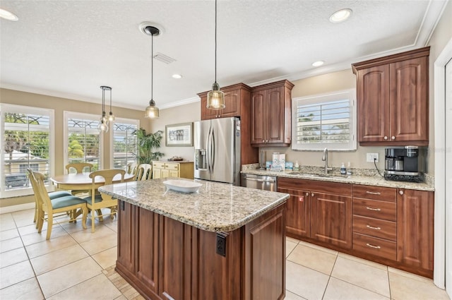 202 75th St, Holmes Beach, FL 34217 - kitchen with stainless steel appliances, crown molding, light tile patterned flooring, a center island, and light stone counters