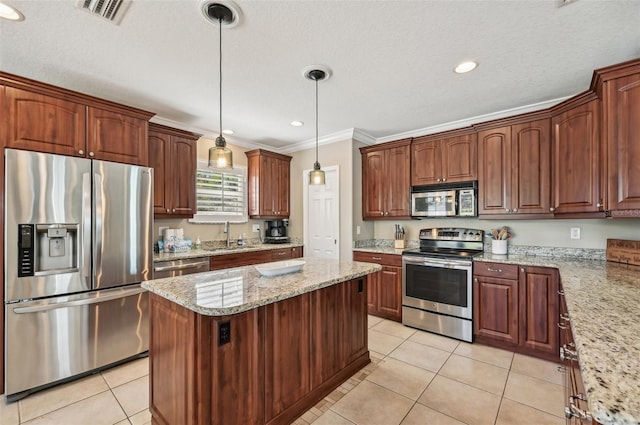 202 75th St, Holmes Beach, FL 34217 - kitchen with appliances with stainless steel finishes, a kitchen island, light tile patterned flooring, crown molding, and pendant lighting