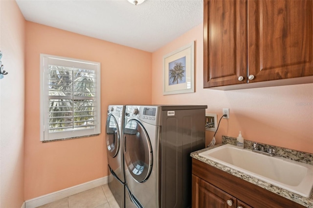 202 75th St, Holmes Beach, FL 34217 - laundry room featuring washer and clothes dryer, cabinet space, and light tile patterned flooring
