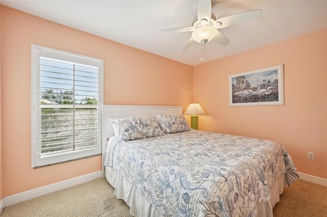 202 75th St, Holmes Beach, FL 34217 - carpeted bedroom with baseboards and a ceiling fan