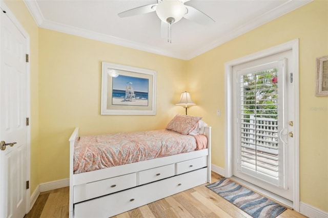 202 75th St, Holmes Beach, FL 34217 - bedroom featuring wood finished floors, access to exterior, crown molding, and ceiling fan