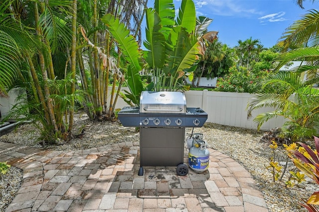 202 75th St, Holmes Beach, FL 34217 - fenced backyard with grilling area and a patio