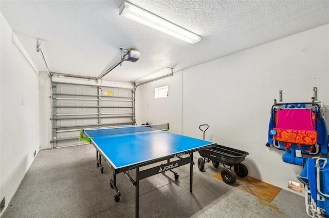 202 75th St, Holmes Beach, FL 34217 - recreation room featuring a textured ceiling, a garage, and concrete floors