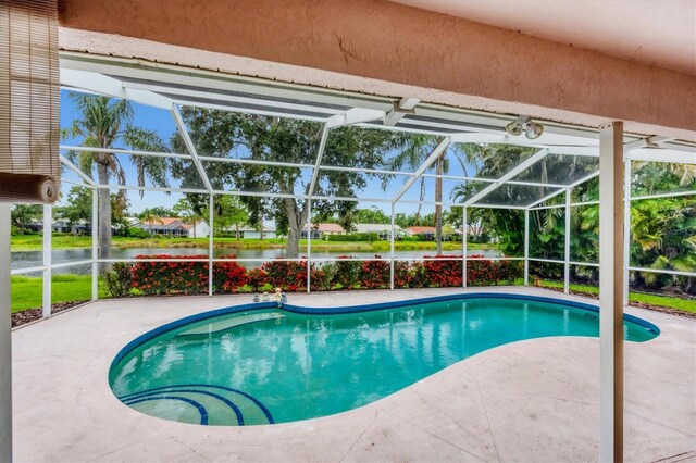 5766 Beaurivage Ave, Sarasota, FL 34243 - swimming pool featuring a water view, a patio, and a lanai