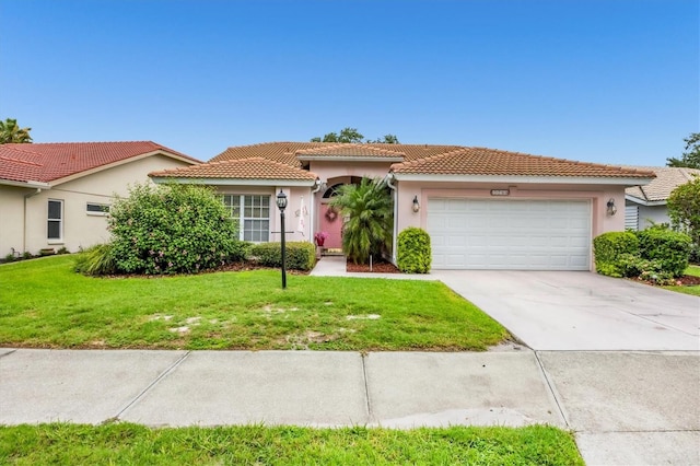 5766 Beaurivage Ave, Sarasota, FL 34243 - view of front of home with a garage, stucco siding, a tile roof, driveway, and a front yard