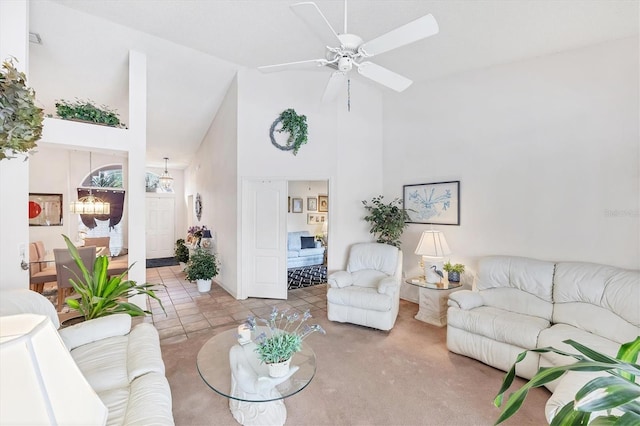 5766 Beaurivage Ave, Sarasota, FL 34243 - living room with high vaulted ceiling, a ceiling fan, carpet flooring, and tile patterned flooring