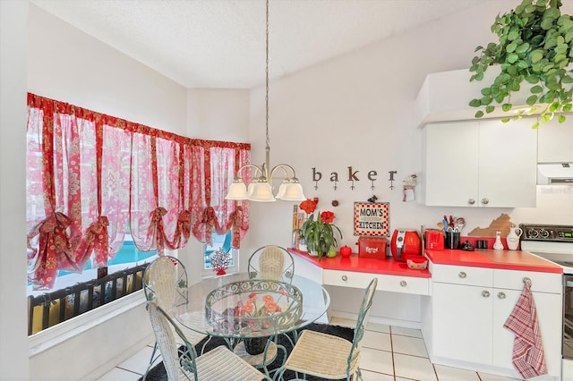 5766 Beaurivage Ave, Sarasota, FL 34243 - dining space with light tile patterned flooring and a chandelier