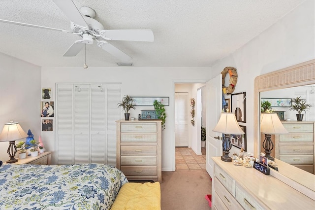 5766 Beaurivage Ave, Sarasota, FL 34243 - bedroom with a closet, light colored carpet, a ceiling fan, and a textured ceiling