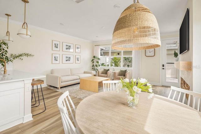 12017 Cranston Way, Bradenton, FL 34211 - dining space with light wood finished floors and ornamental molding