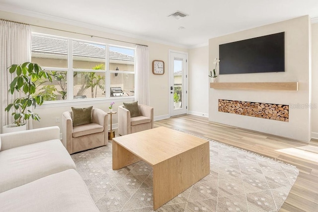 12017 Cranston Way, Bradenton, FL 34211 - living room featuring crown molding and light wood finished floors