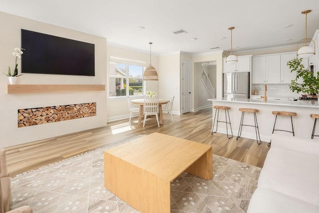 12017 Cranston Way, Bradenton, FL 34211 - living room featuring ornamental molding and light wood-style floors