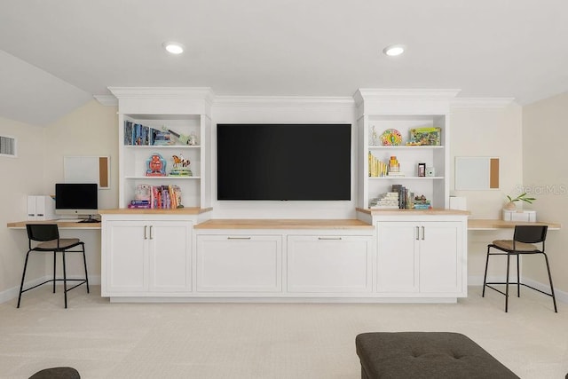 12017 Cranston Way, Bradenton, FL 34211 - living room with an office area, light colored carpet, built in shelves, ornamental molding, and lofted ceiling