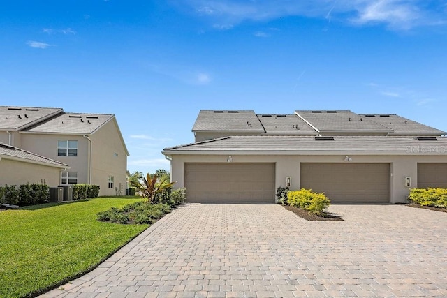 12017 Cranston Way, Bradenton, FL 34211 - view of front facade with a front yard, stucco siding, decorative driveway, a tiled roof, and a garage