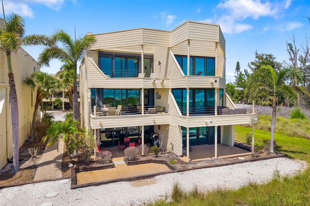 546A Beach Rd Unit A544, Sarasota, FL 34242 - rear view of property featuring a balcony and a patio