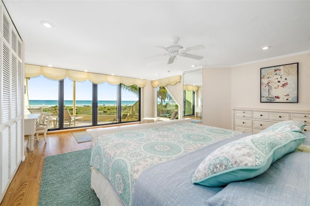 546A Beach Rd Unit A544, Sarasota, FL 34242 - bedroom with light wood-type flooring, a water view, ornamental molding, recessed lighting, and access to outside