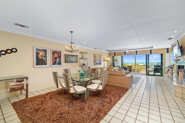 546A Beach Rd Unit A544, Sarasota, FL 34242 - dining area with light tile patterned floors, a chandelier, floor to ceiling windows, and crown molding