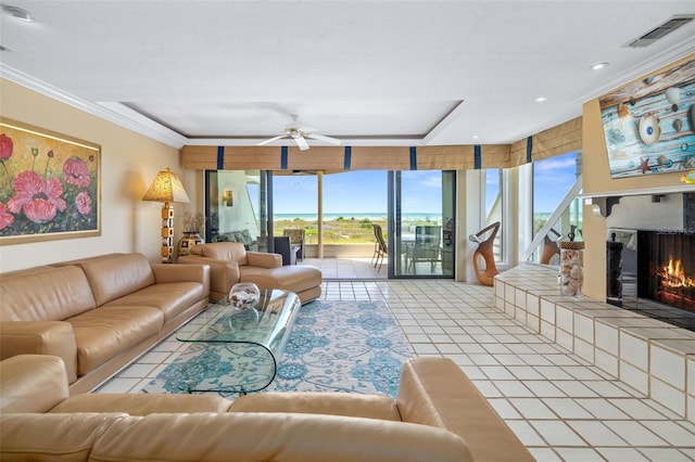546A Beach Rd Unit A544, Sarasota, FL 34242 - tiled living room with a lit fireplace, ceiling fan, crown molding, and recessed lighting