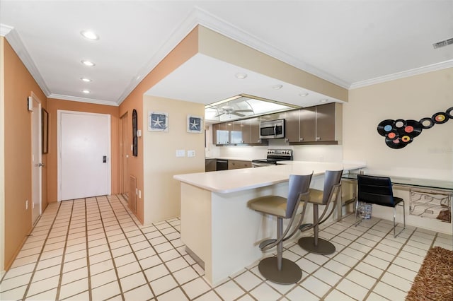 546A Beach Rd Unit A544, Sarasota, FL 34242 - kitchen with stainless steel appliances, a peninsula, ornamental molding, a breakfast bar, and recessed lighting