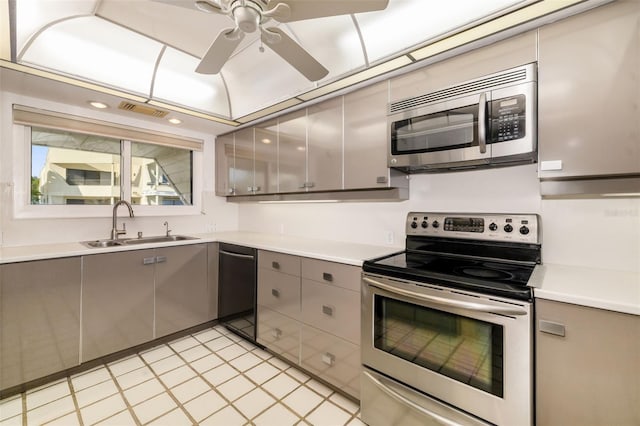 546A Beach Rd Unit A544, Sarasota, FL 34242 - kitchen featuring appliances with stainless steel finishes, gray cabinetry, a ceiling fan, light countertops, and light tile patterned floors