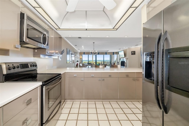 546A Beach Rd Unit A544, Sarasota, FL 34242 - kitchen featuring stainless steel appliances, a chandelier, light countertops, a peninsula, and recessed lighting